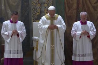 Pope Leo prays during the Mass